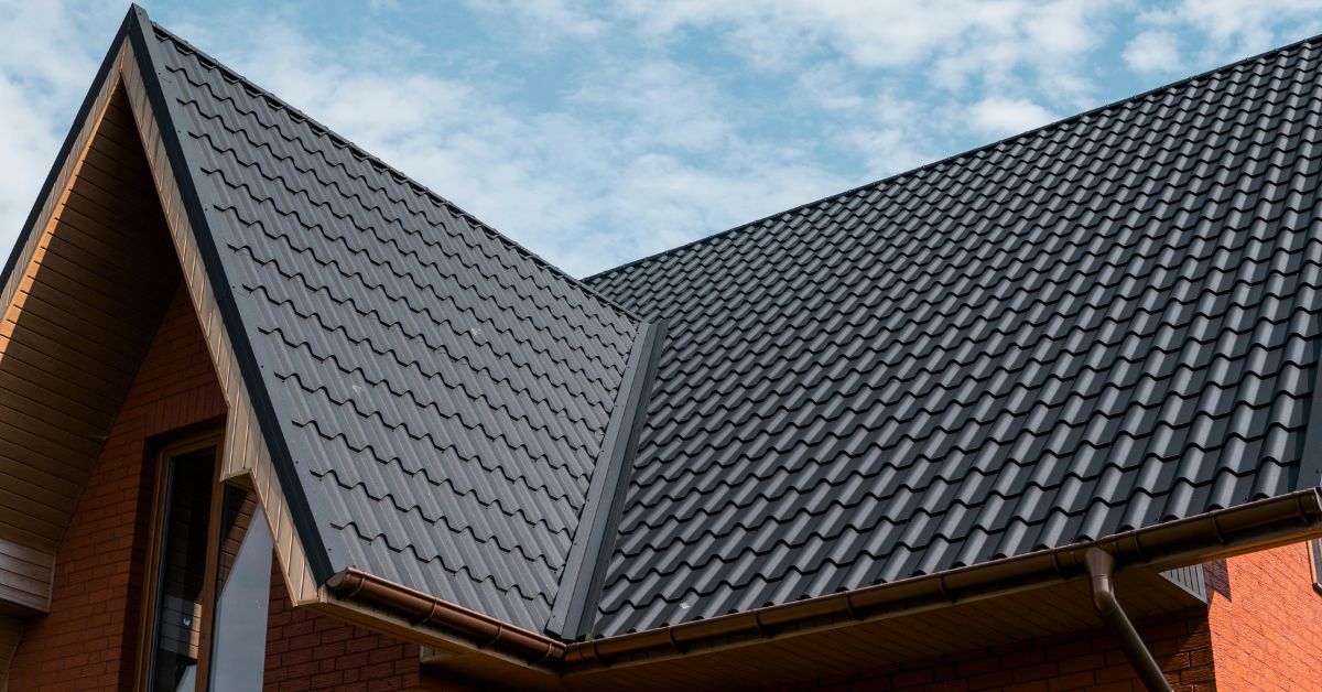 Looking up at a new house with new clay spanish tile roof installation