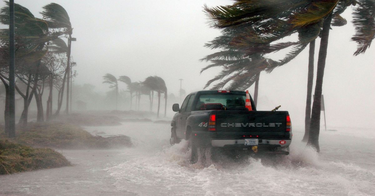 pickup truck driving through heavy rain and flooded streets