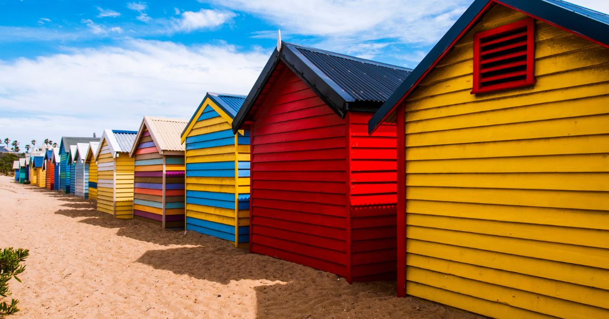 Small houses on the beach with different colored roofs