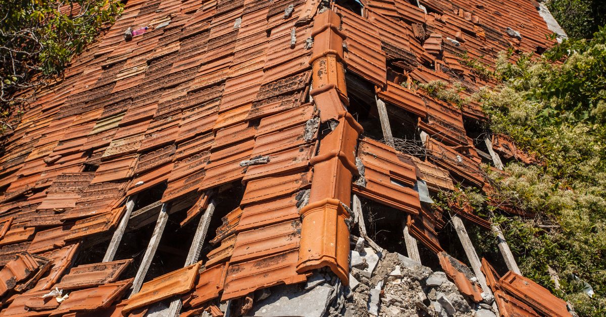 Top view of spanish clay tile roof falling apart needs new roof replacement