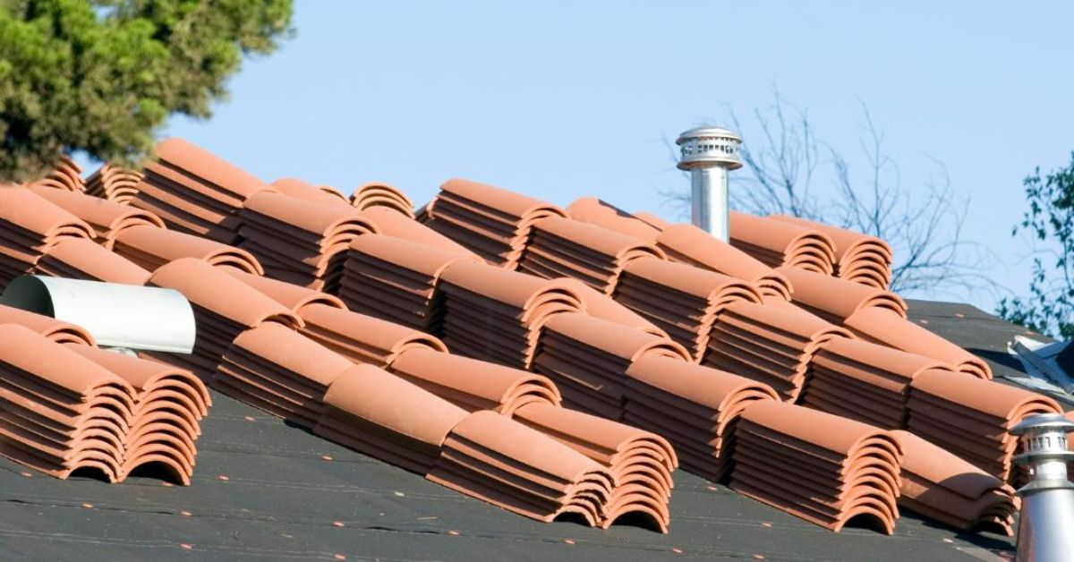 pile of clay spanish style roof tiles on roof ready for new roof installation